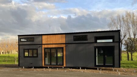 Two-Story Oasis Tiny House Fits Three Bedrooms in Sunlit Interior, Ideal for Family Downsizing Oasis Tiny House