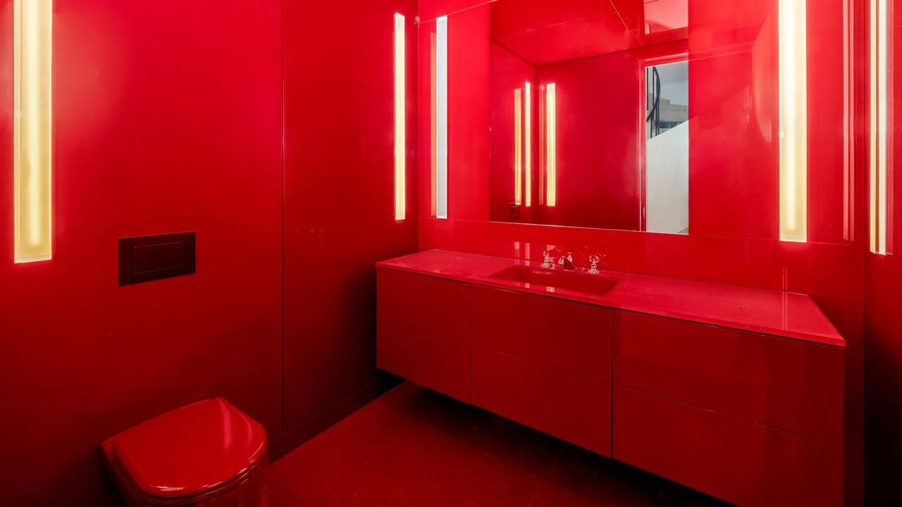 The eye-catching crimson interior of the powder room