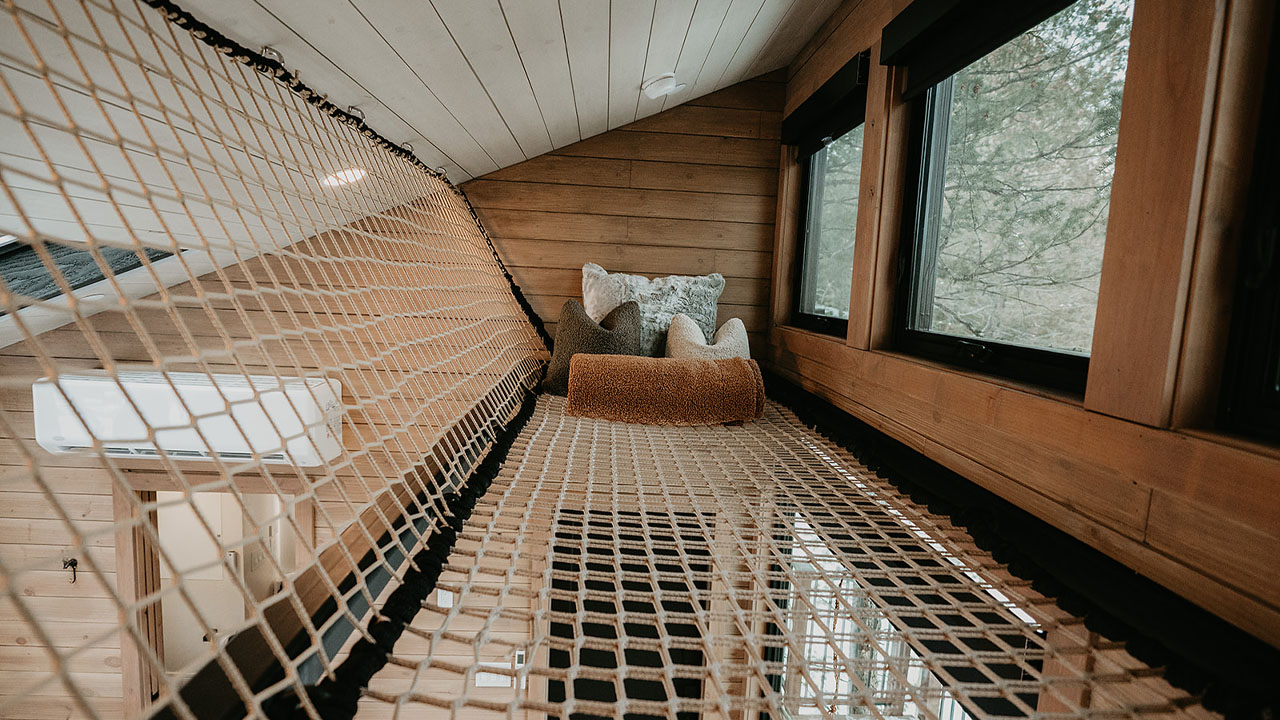 Experience mid-air lounging in the lofted hammock net and admire the quaint forested landscape through the glazing.