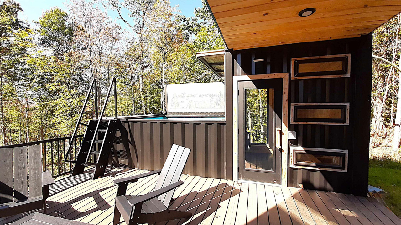 The large wooden deck is ideal for outdoor dining, lounging and leads to the plunge pool and sauna via the stairs.