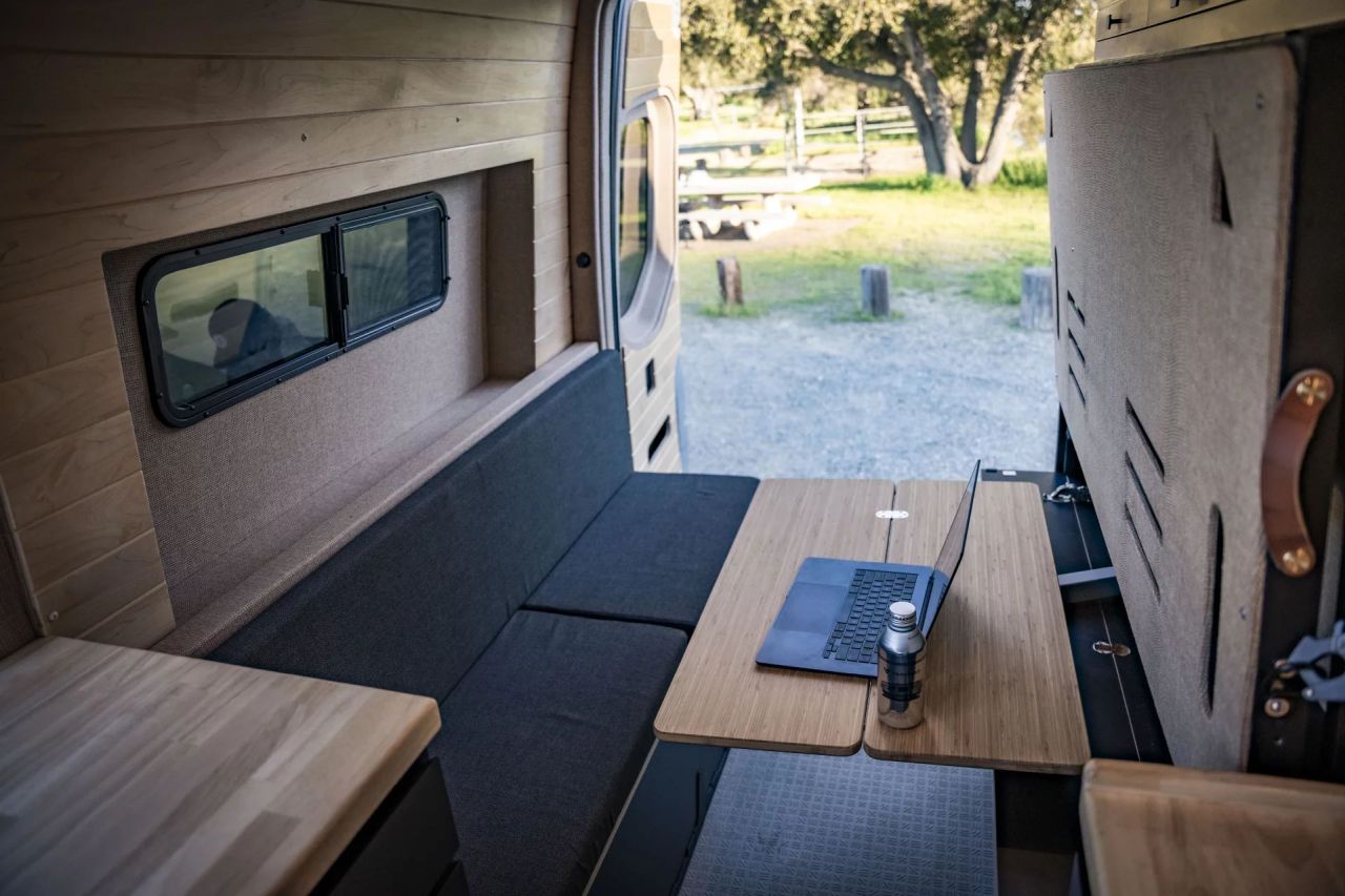Vanspeed Album Camper Van With Multifunctional Layout - workspace with hidden table and bench seating