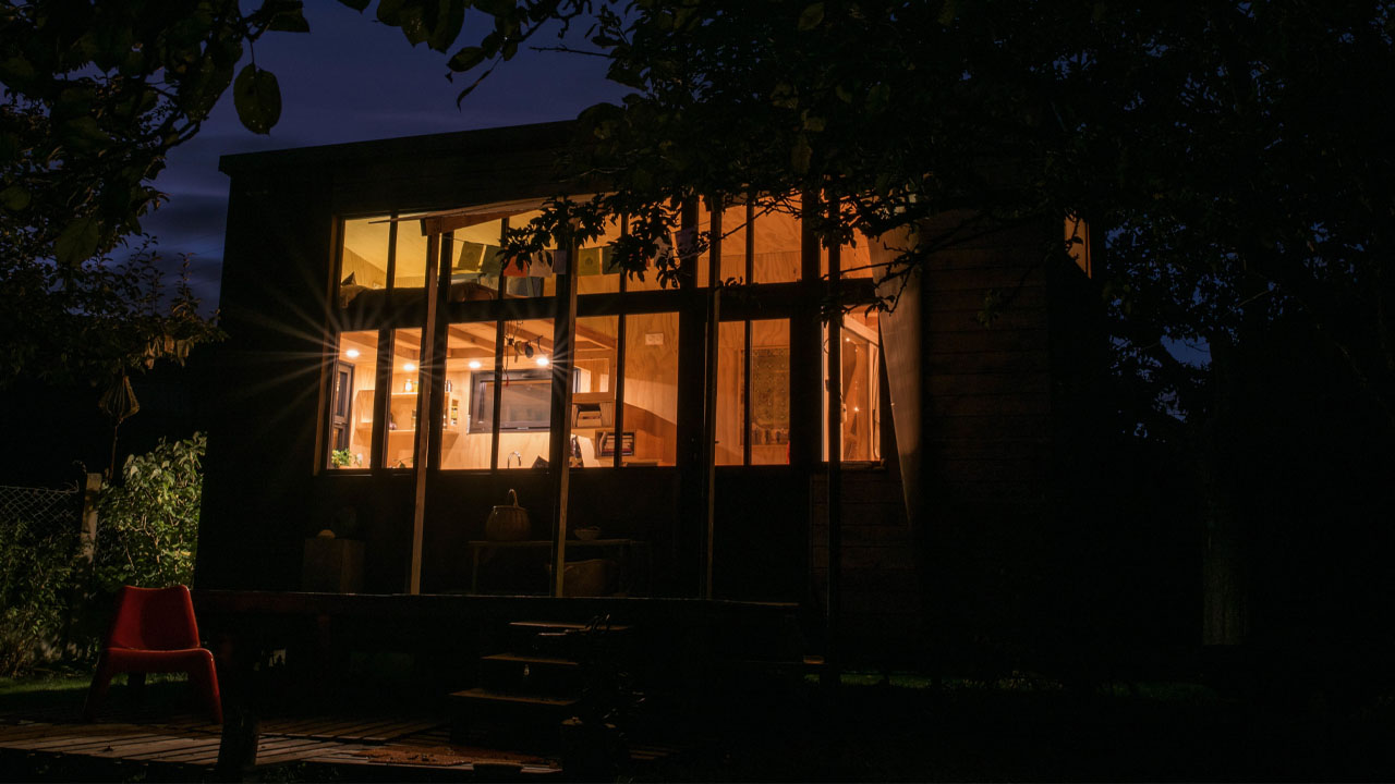 The tiny house glows like a lamp during night