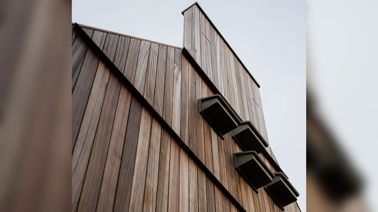 The wooden chimney on corner of the gabled wooden roof serve as place for bats to build nest