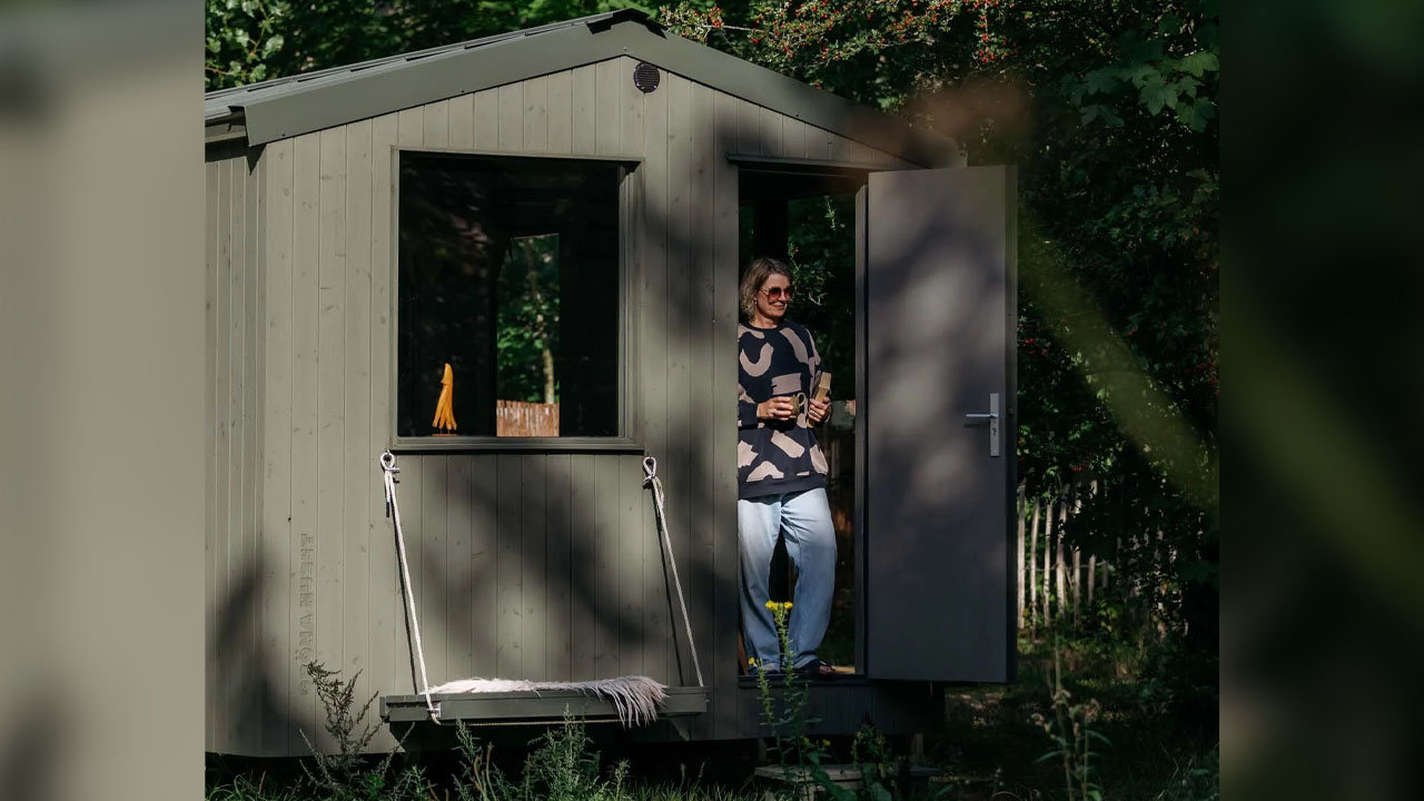 The calm sage green color of the tiny house