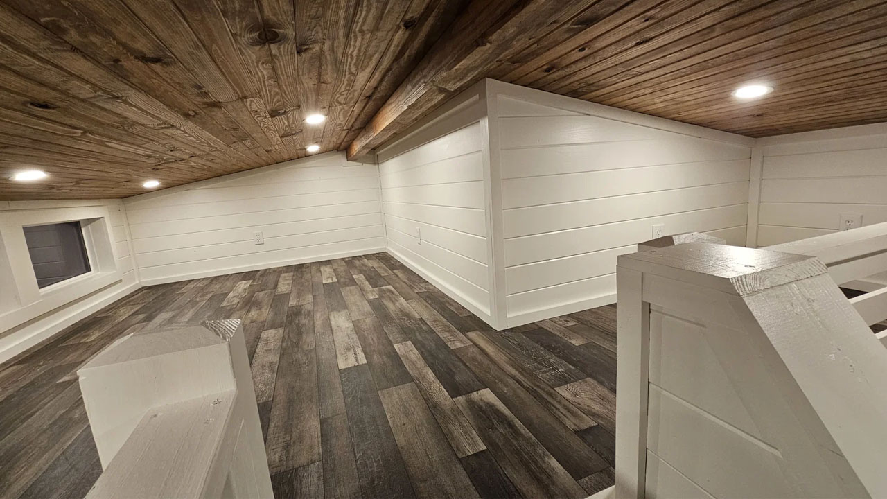 The spacious loft with recessed roof lighting and generous glazing