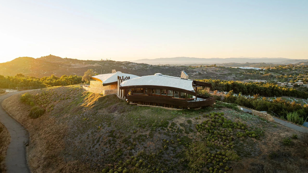 The building looks like an extension of the rocky terrain