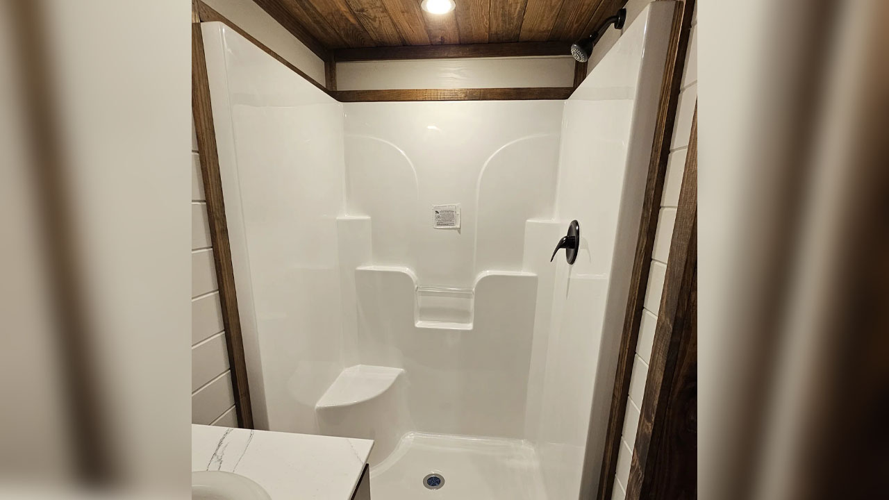 The shower room has complete white finish