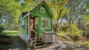 $77K Green Fairytale Tiny House is Matrix of Hidden Space-Efficient Utilities in Captivating Interior The charming mini cottage house beautifully blends into the woodland