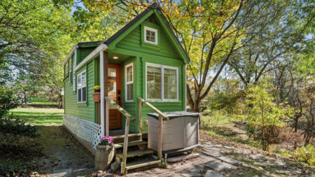 $77K Green Fairytale Tiny House is Matrix of Hidden Space-Efficient Utilities in Captivating Interior The charming mini cottage house beautifully blends into the woodland