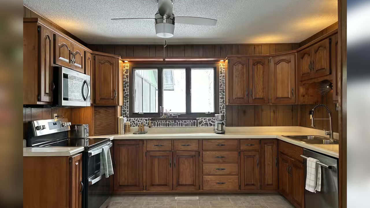 The functional kitchen has ample wooden cabinetry