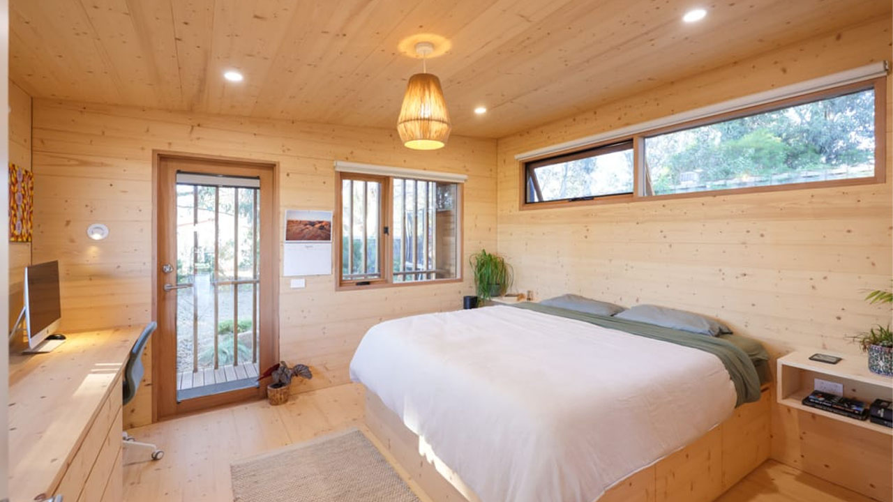 The cozy primary bedroom with a private balcony
