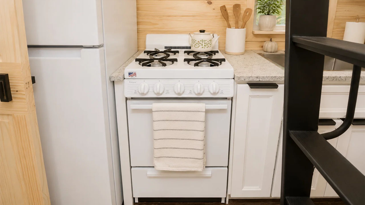 The functional kitchen has integrated stove and oven