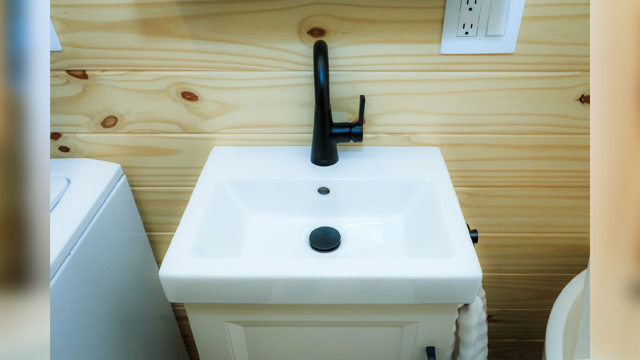 The compact vanity sink in bathroom