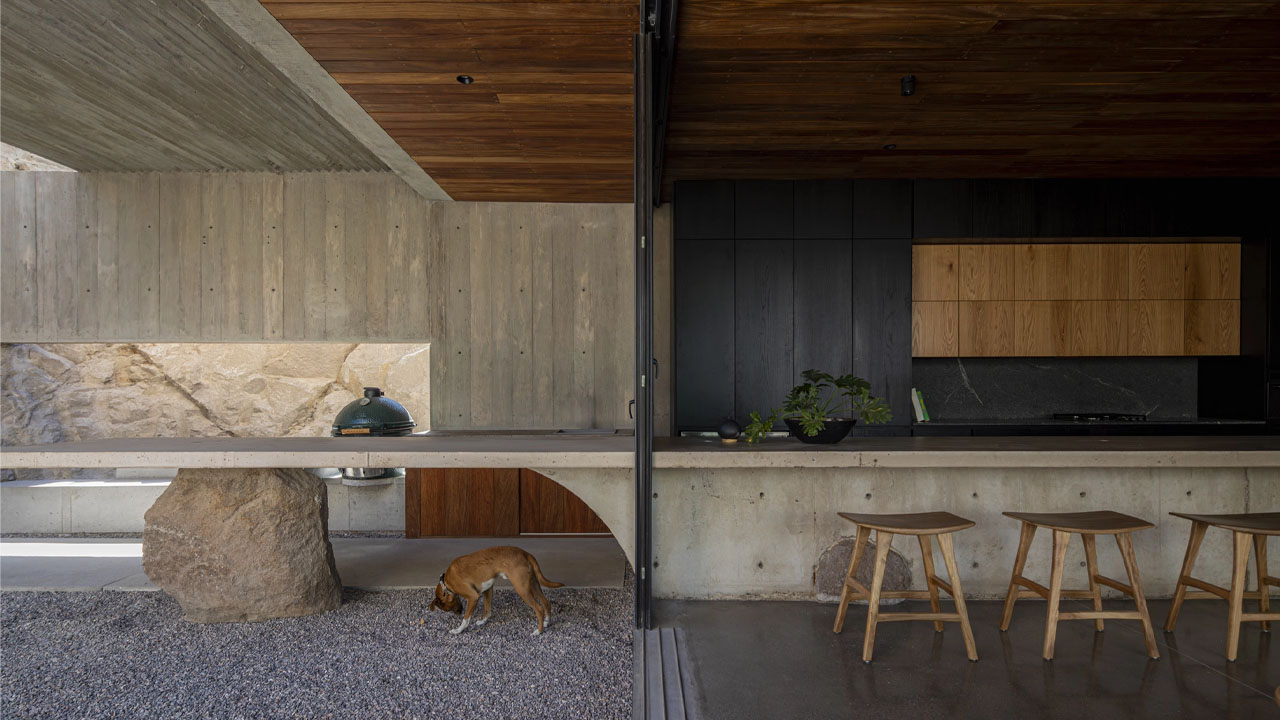 The raw boulder supporting the kitchen counter
