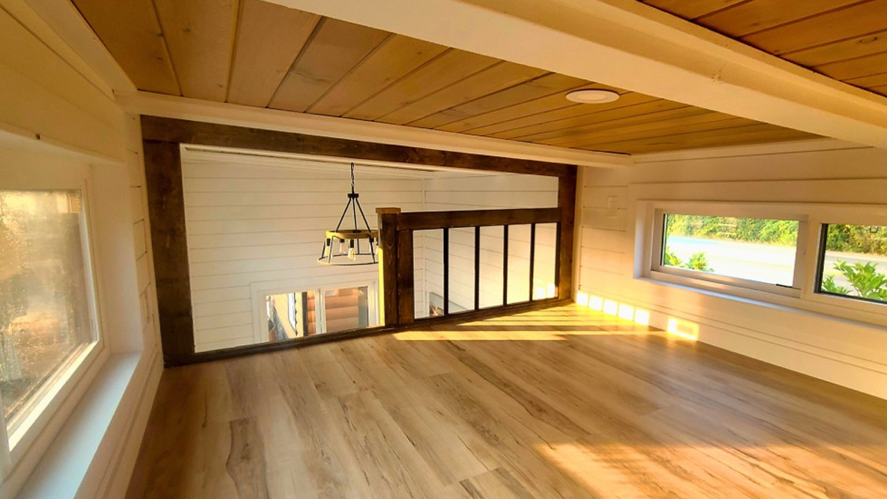 well-lit loft bedroom of cinnamon bear tiny house