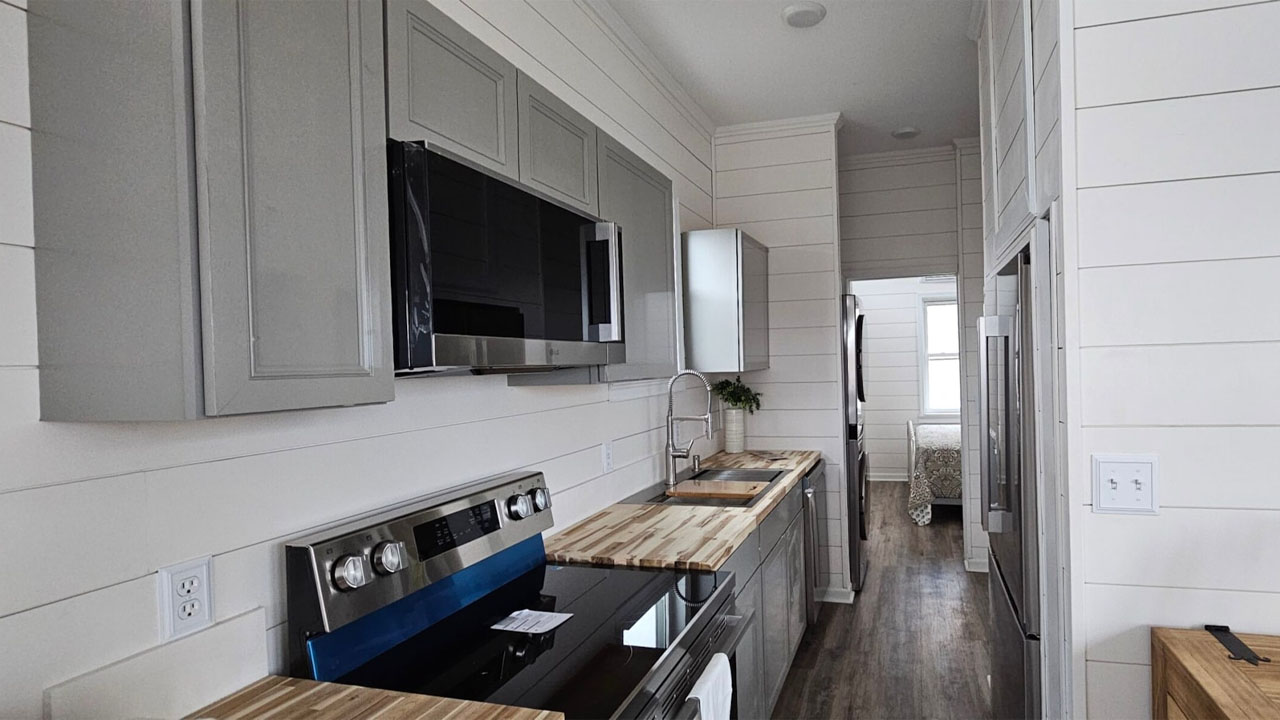 The raw texture of butcher block countertop provides tactile richness