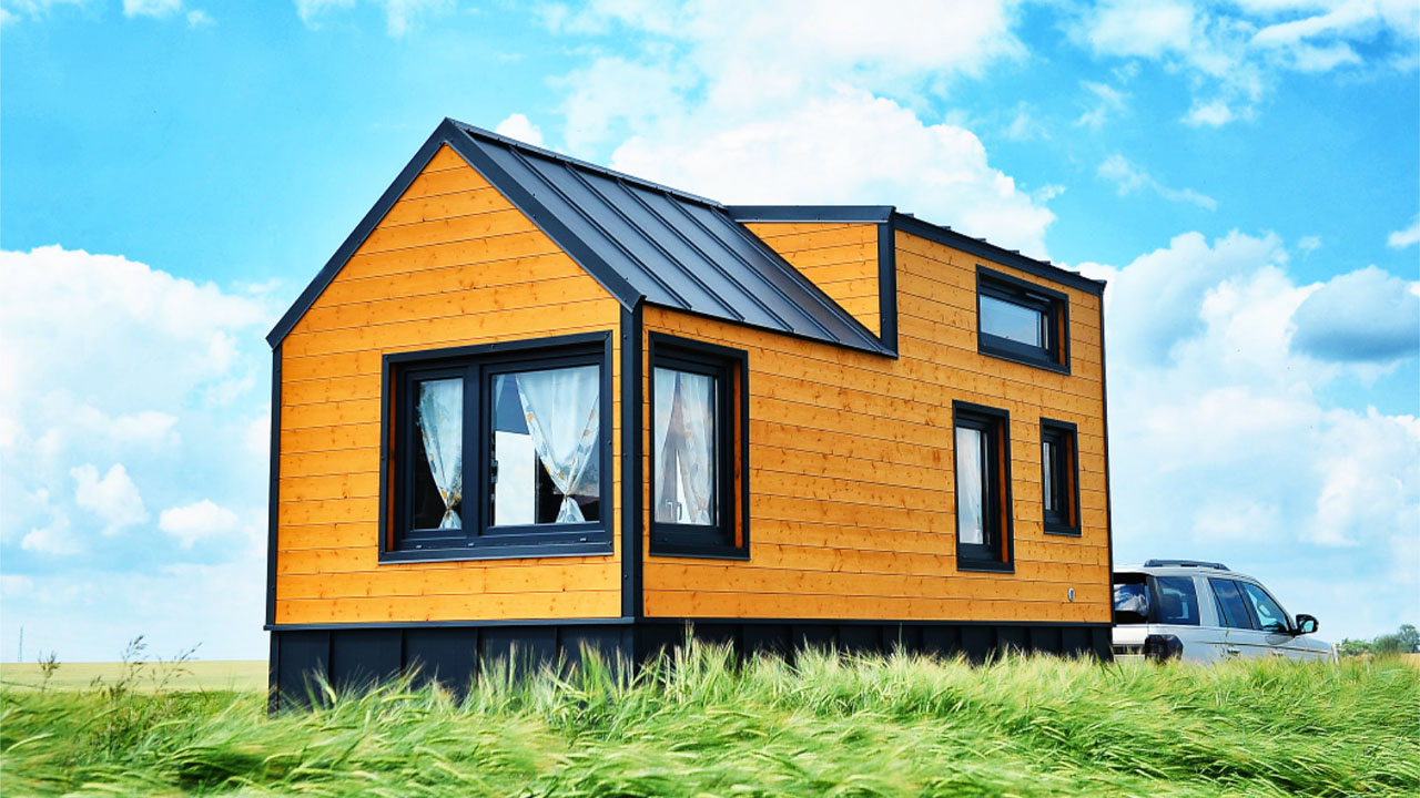 The gorgeous honey-yellow color with metal trim gives striking appearance to the Emilie tiny house