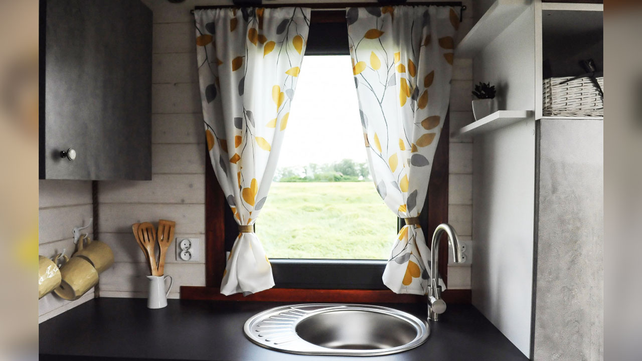 The botanical prints of the curtain adds farmhouse charm to the space