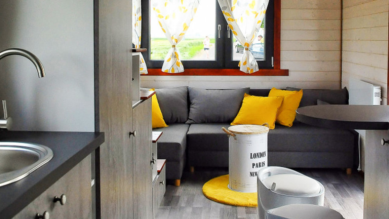 The living space looks bright and the round coffee table looks like a collectible item
