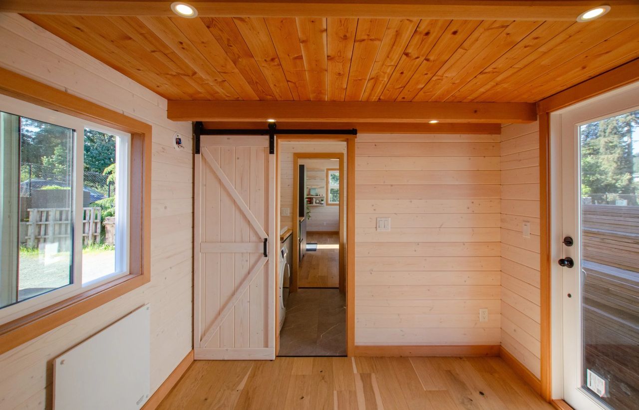 Interior and Sliding barn door of Juniper tiny house on wheels