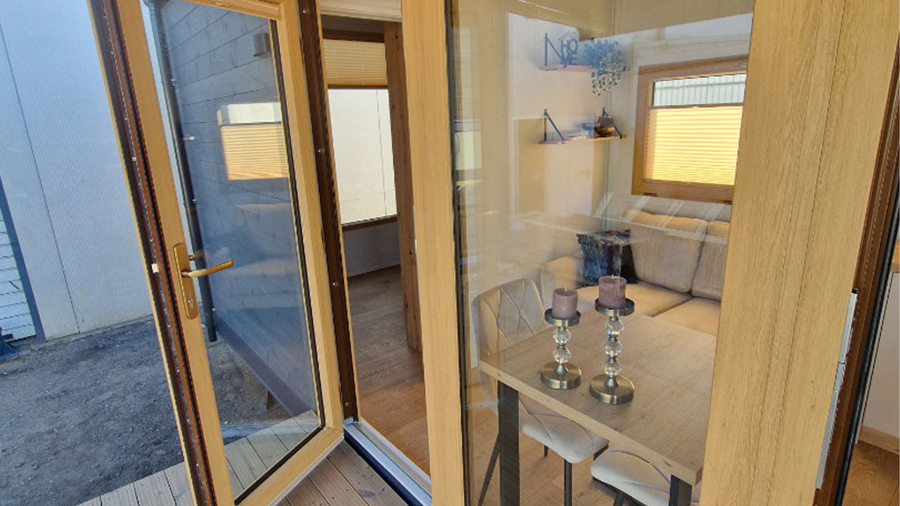 The wooden framed door opens into cozy interior