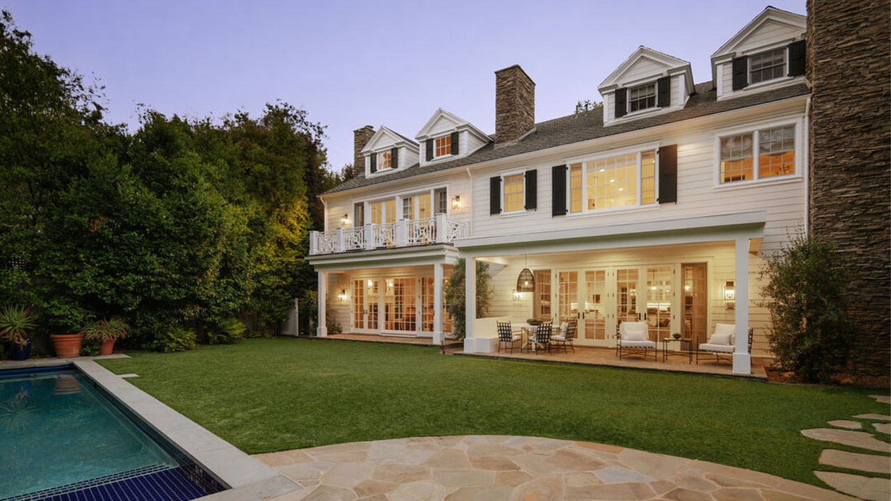 The trimmed lawn, an outdoor pool of Mandeville Canyon Estate