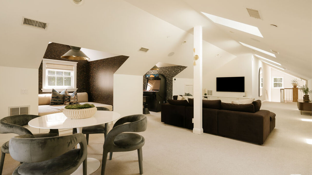 The seating near window and arcade game machine in the attic
