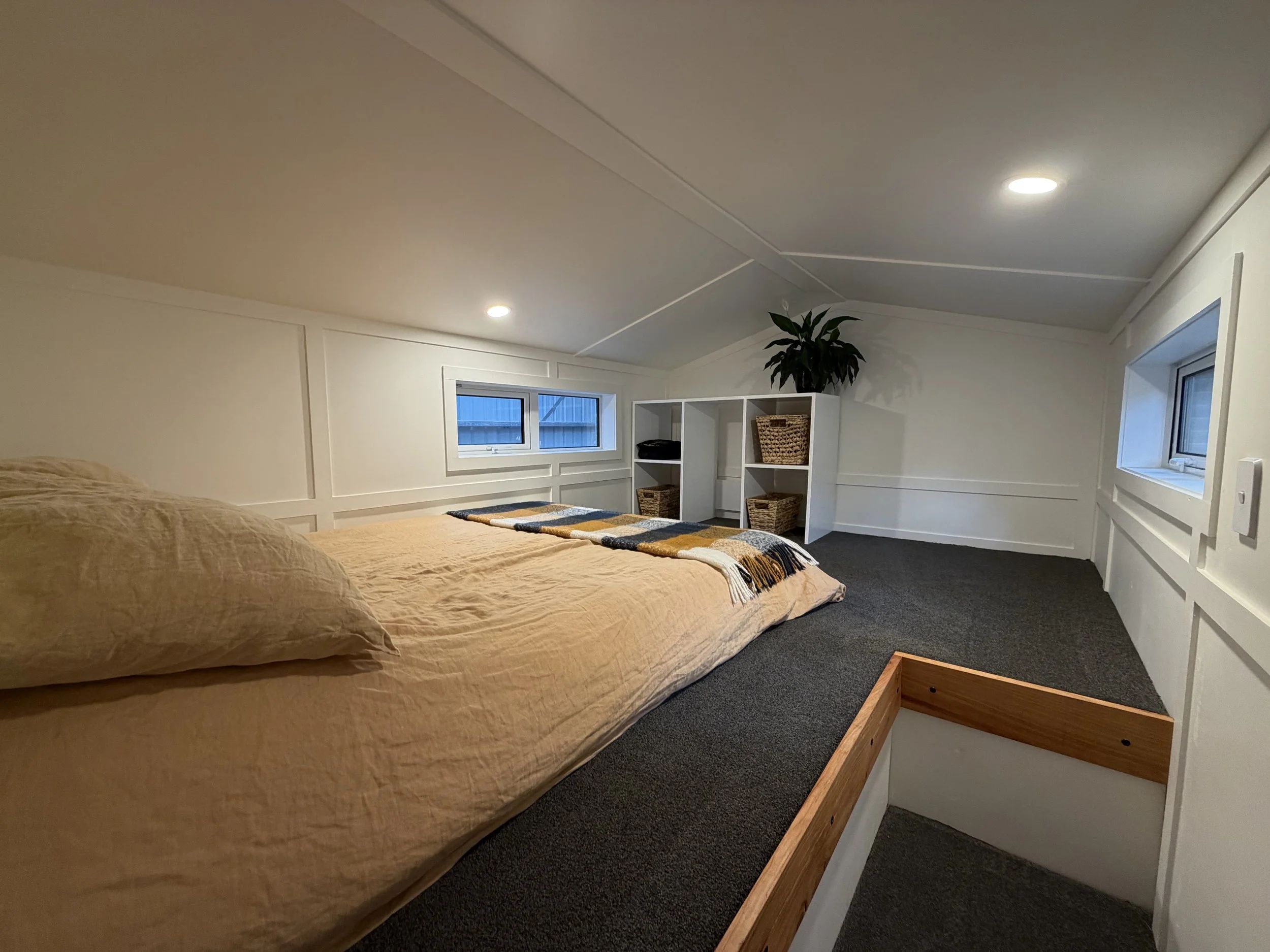 Maple Tiny House Features Overhang Shelf Above Kitchen for Extra Storage Smart Storage Hack