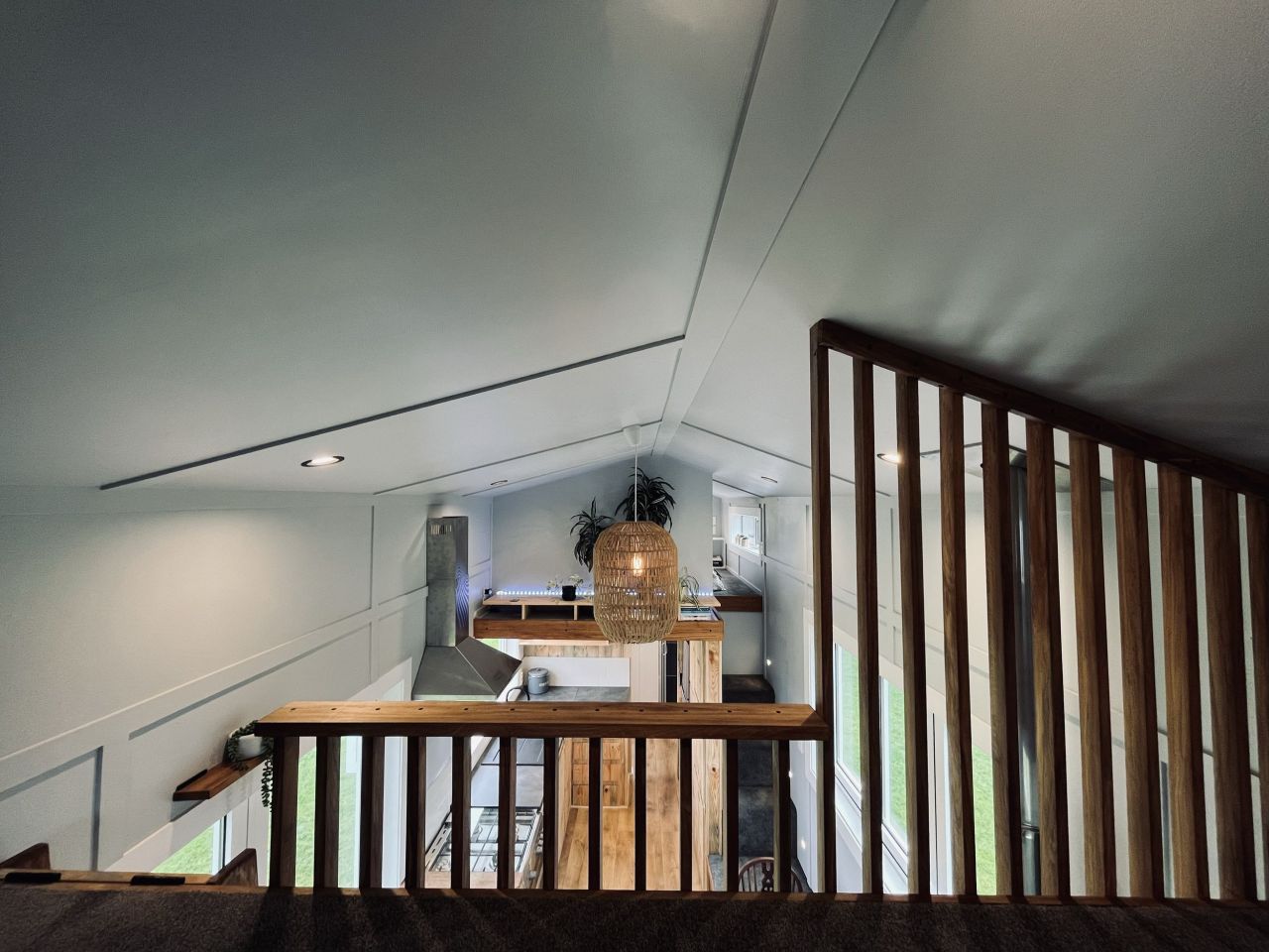 Maple Tiny House Features Overhang Shelf Above Kitchen for Extra Storage Smart Storage Hack
