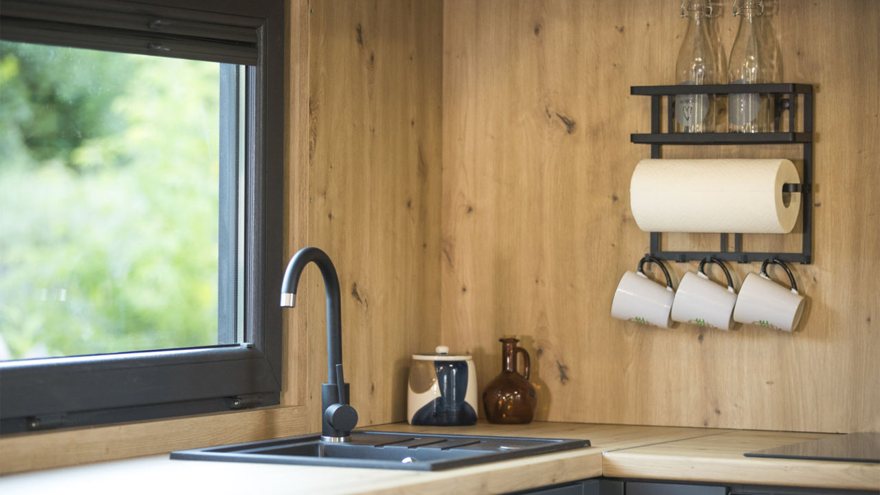 the matte black fixtures contrast against pale spruce wood cladding