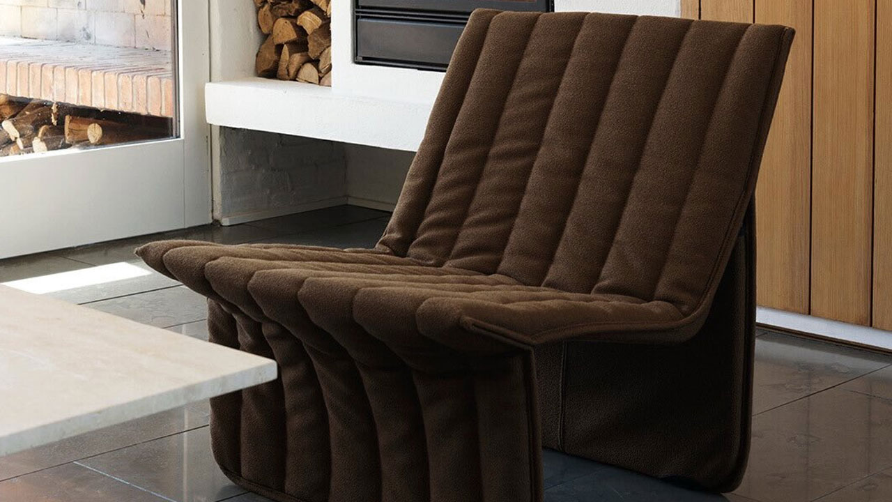 Normann-Copenhagen-Reissues-Flat-Pack-Limit-Lounge-Chair-by-Niels-Bendtsen in brown color 