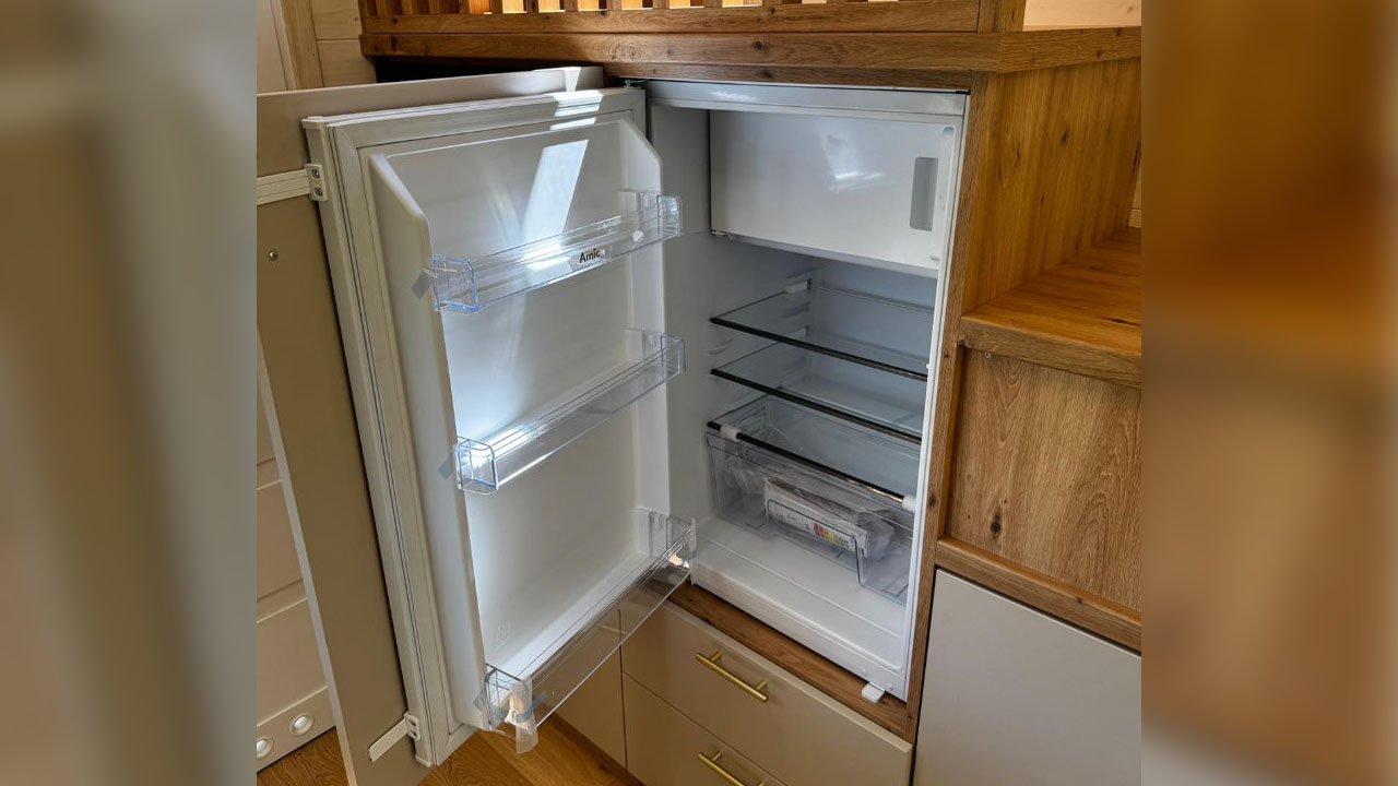 The white fridge in the staircase of Sophia tiny house