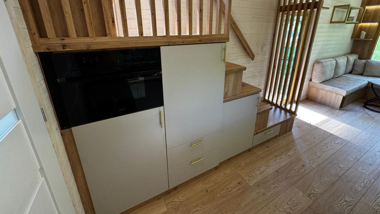 The microwave and refrigerator tucked within the staircase