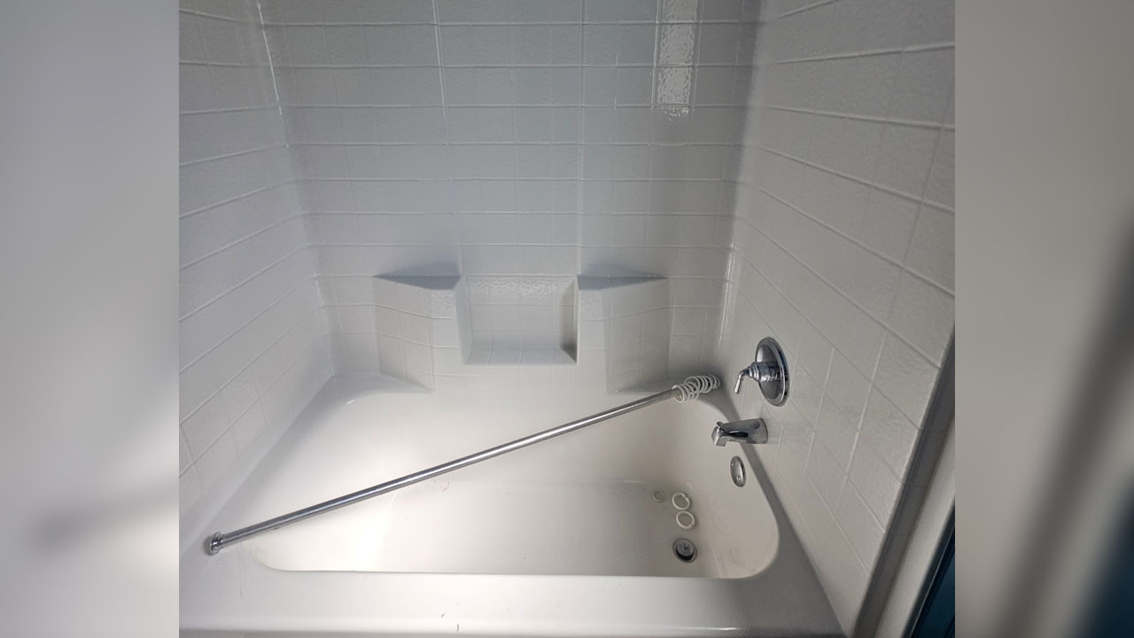 The white bathtub and tiles add spa-like feel to the bathroom