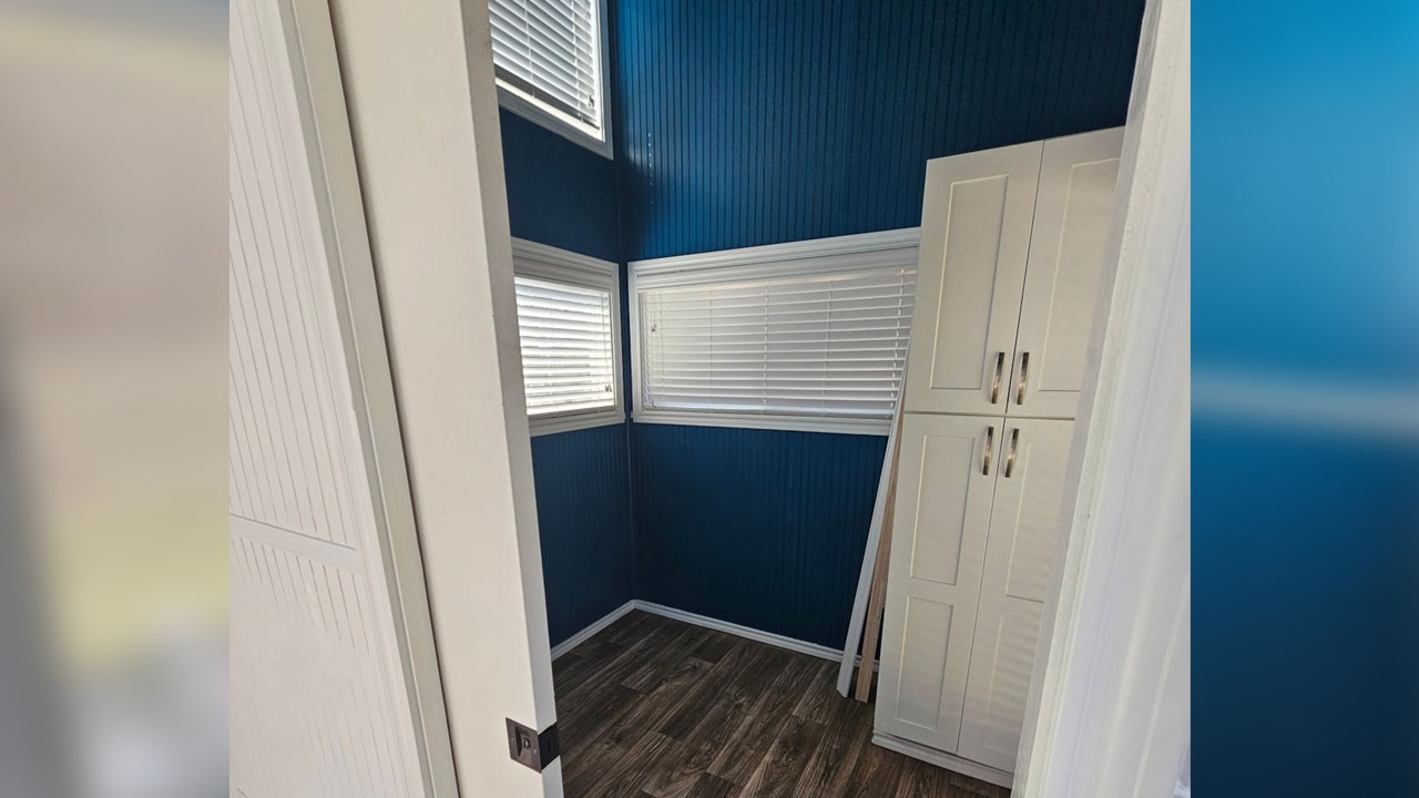 The white wardrobe and white windows equipped with blinders
