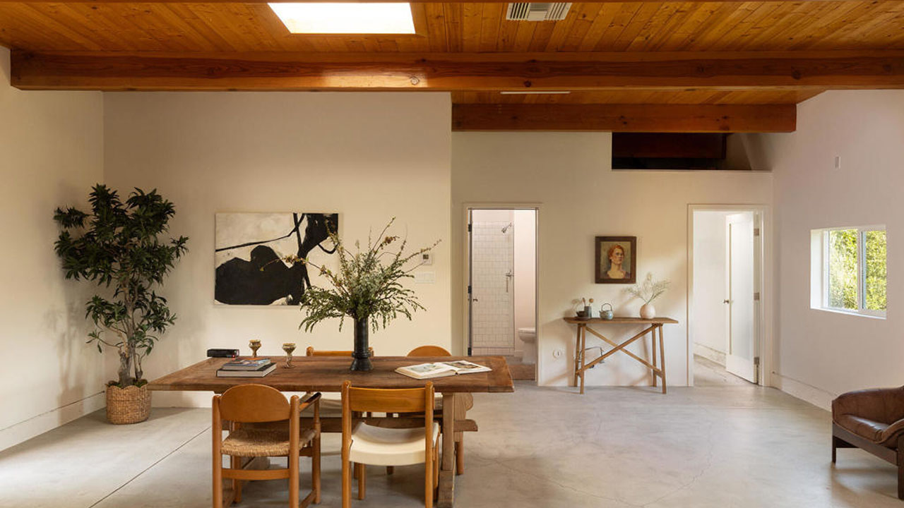 The dining table is neatly placed in the spacious living room