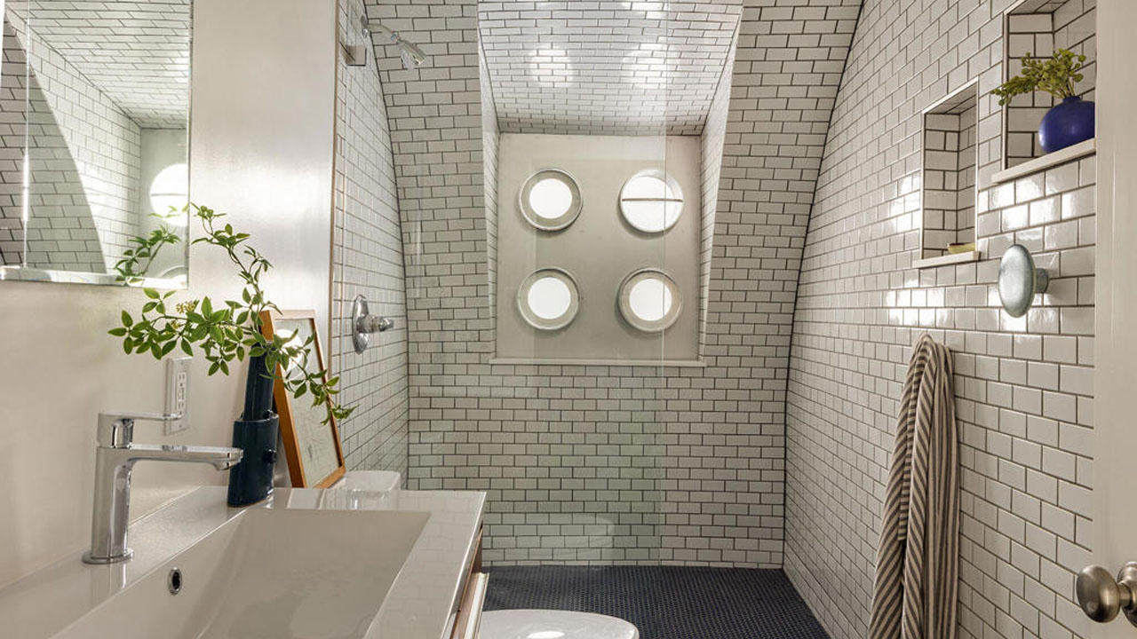 The spacious bathroom has decorative tilework