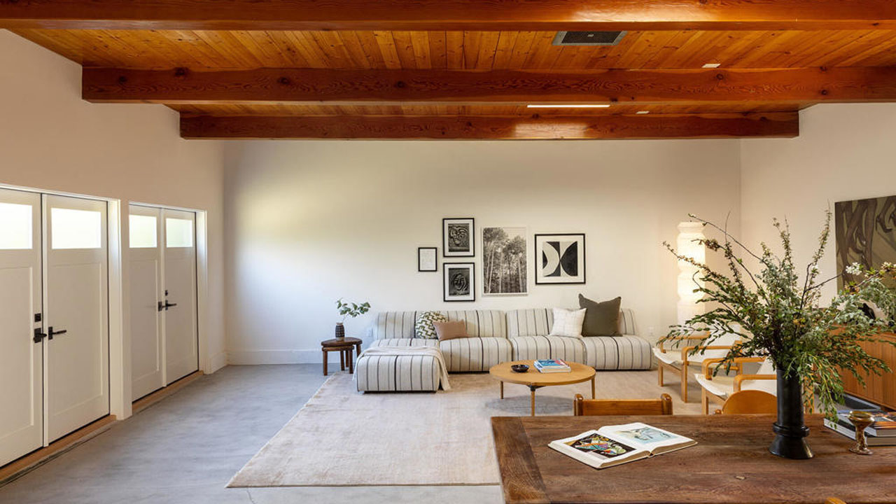 The wooden roof contrasts with the white interior of the studio