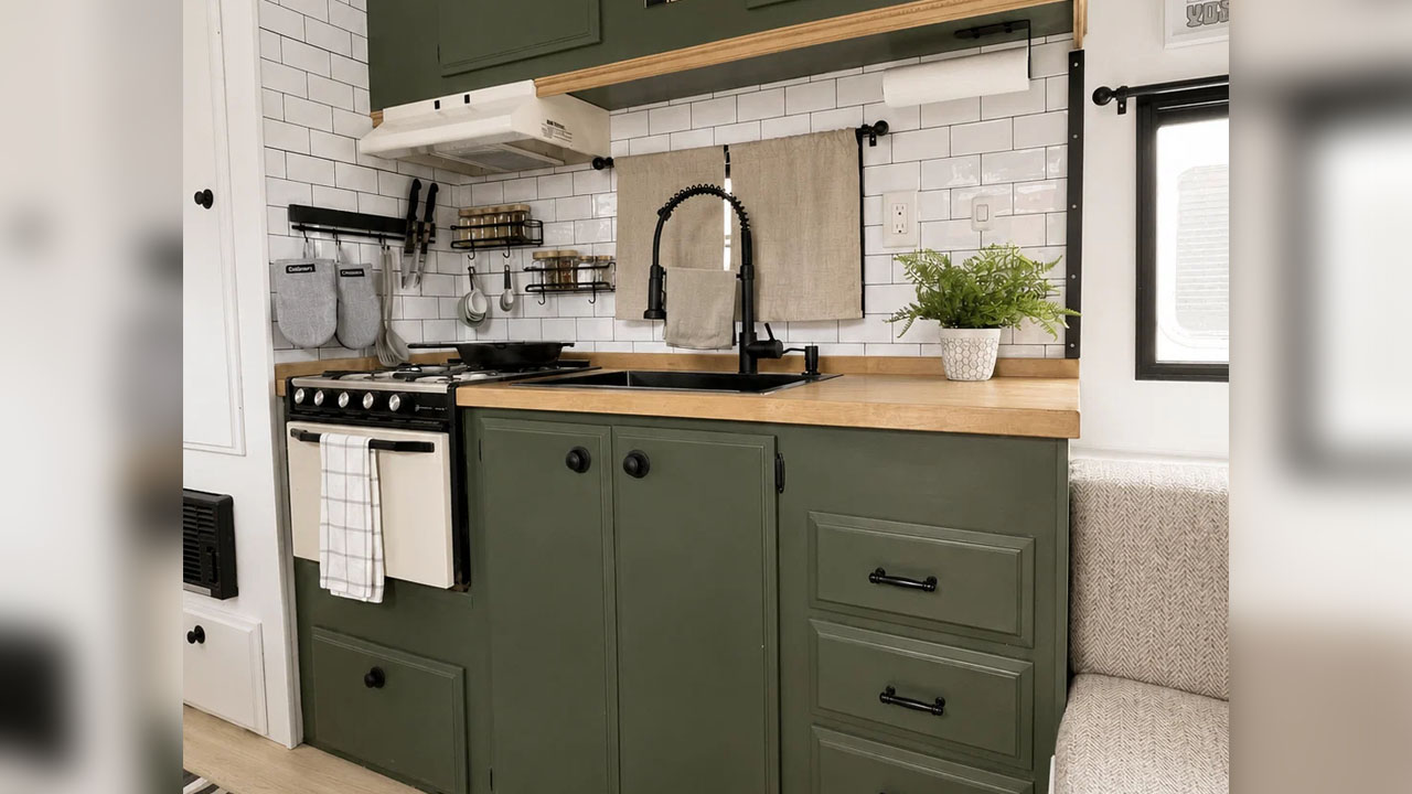 The green-painted cabinetry provides ample storage facilities