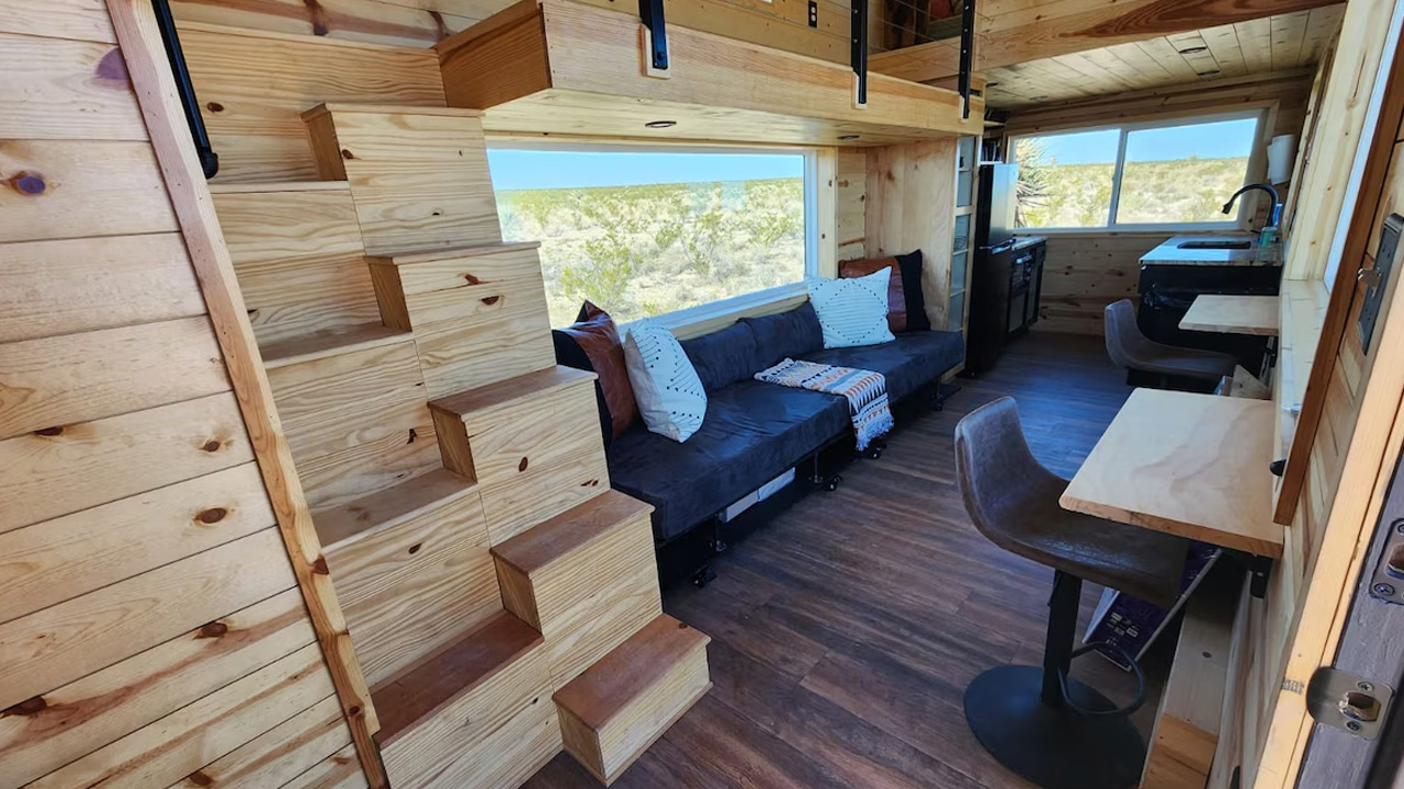 30-foot tiny house lounge area with two fold-down tables