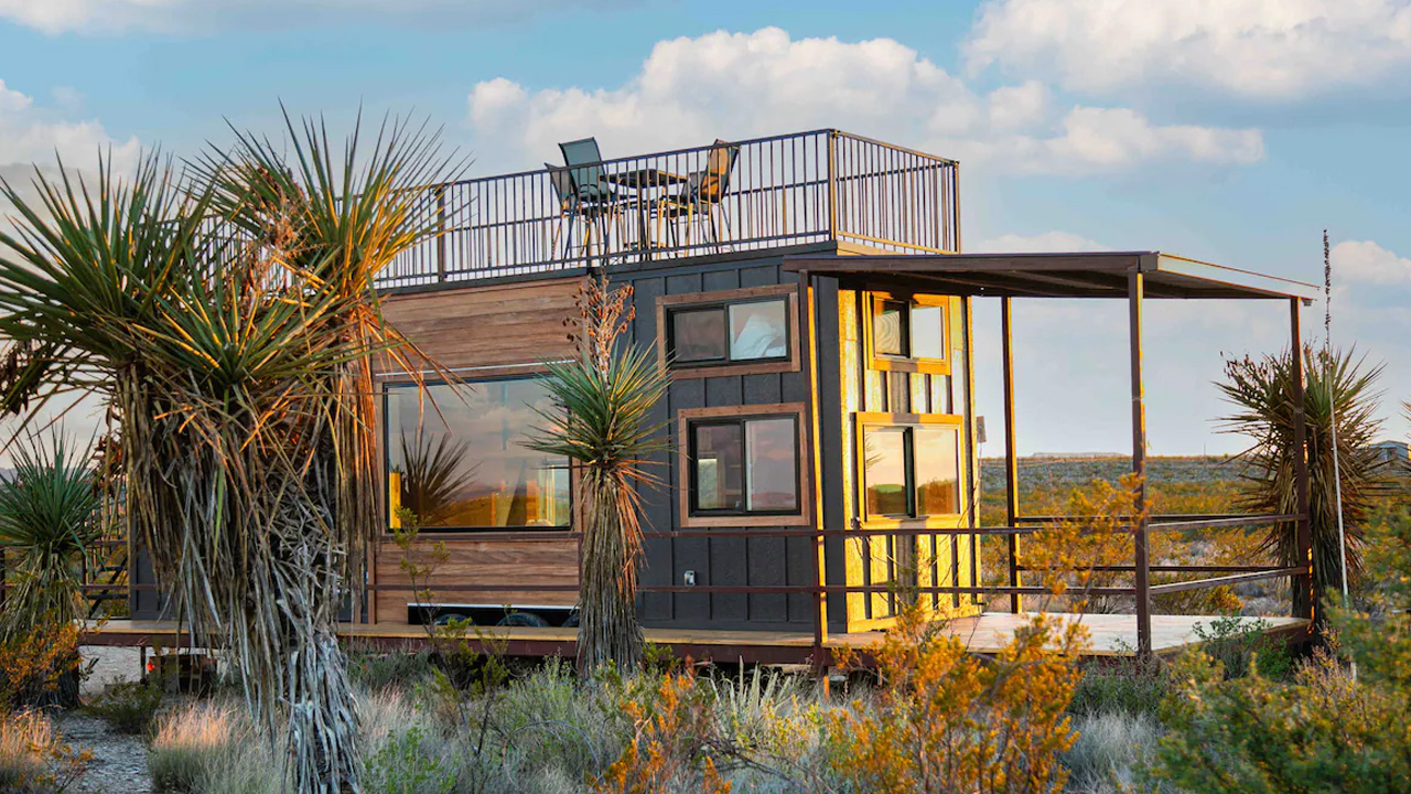 30-foot tiny house with covered porch and rooftop deck