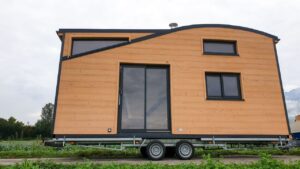 This Chalet-Style Tiny House Rides With Curved Roof and Newborn Onboard Exterior of Virginie and Mathieu Curved-Roof Tiny House