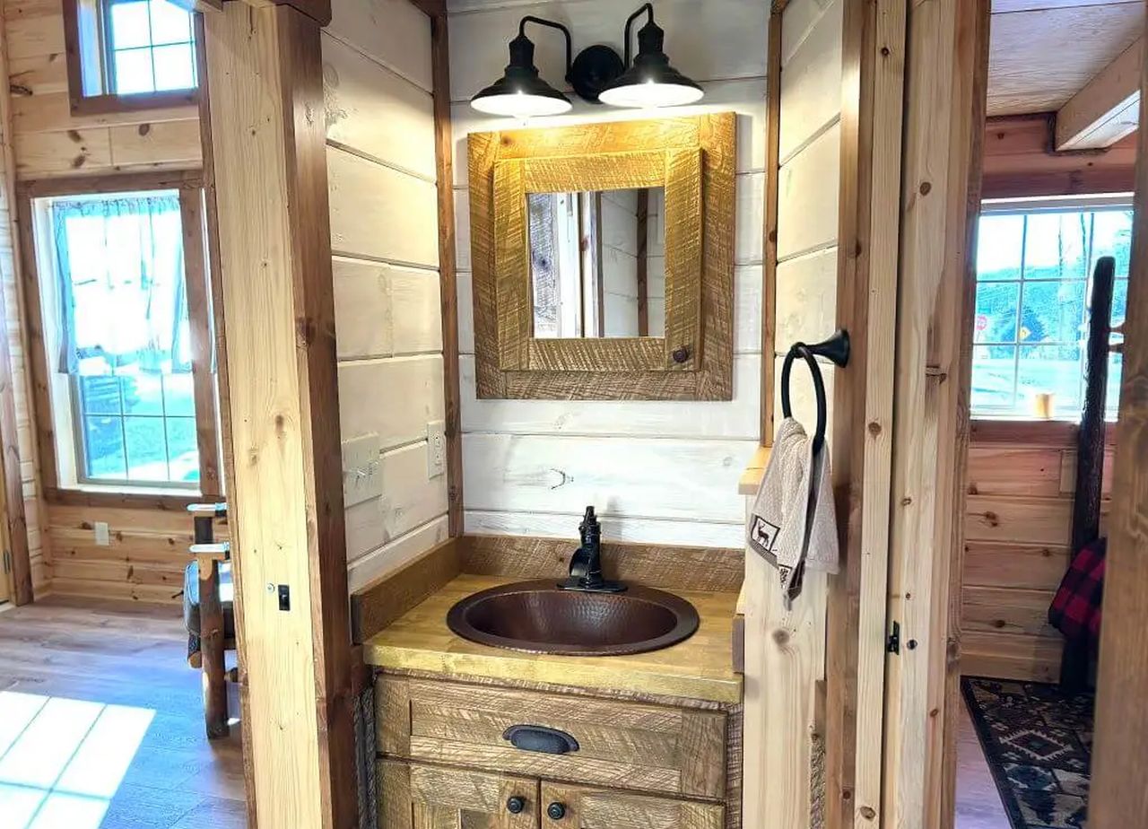 Vanity and sink of Toilet and Bathroom of Kitchen view of Lake Tahoe Tiny House