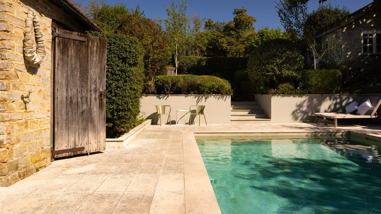 Princess Margaret’s West Sussex Estate-outdoor pool surrounded with greenery