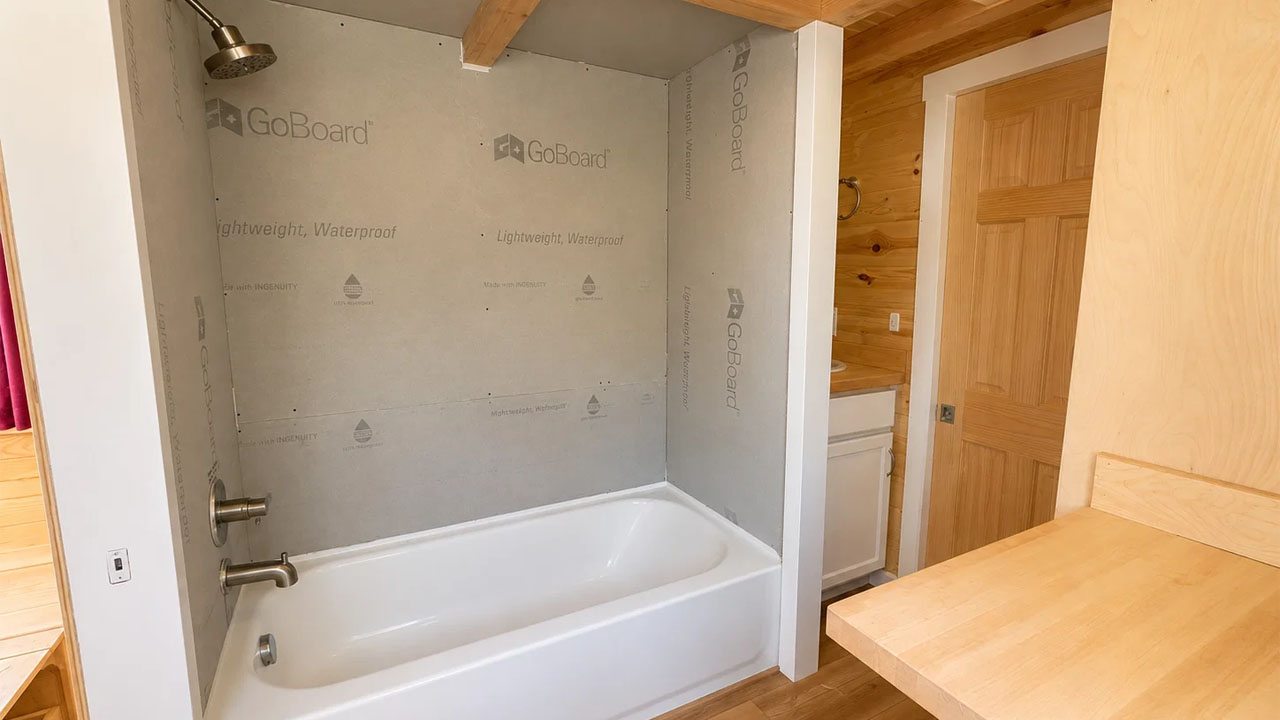 Scandinavian-style tiny house-bathtub with showerhead