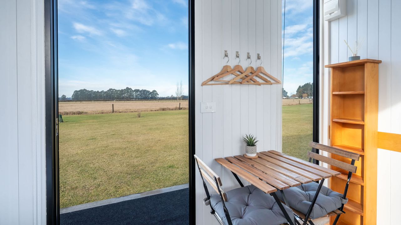 Tiny House with Clever Window Arrangement - dining area