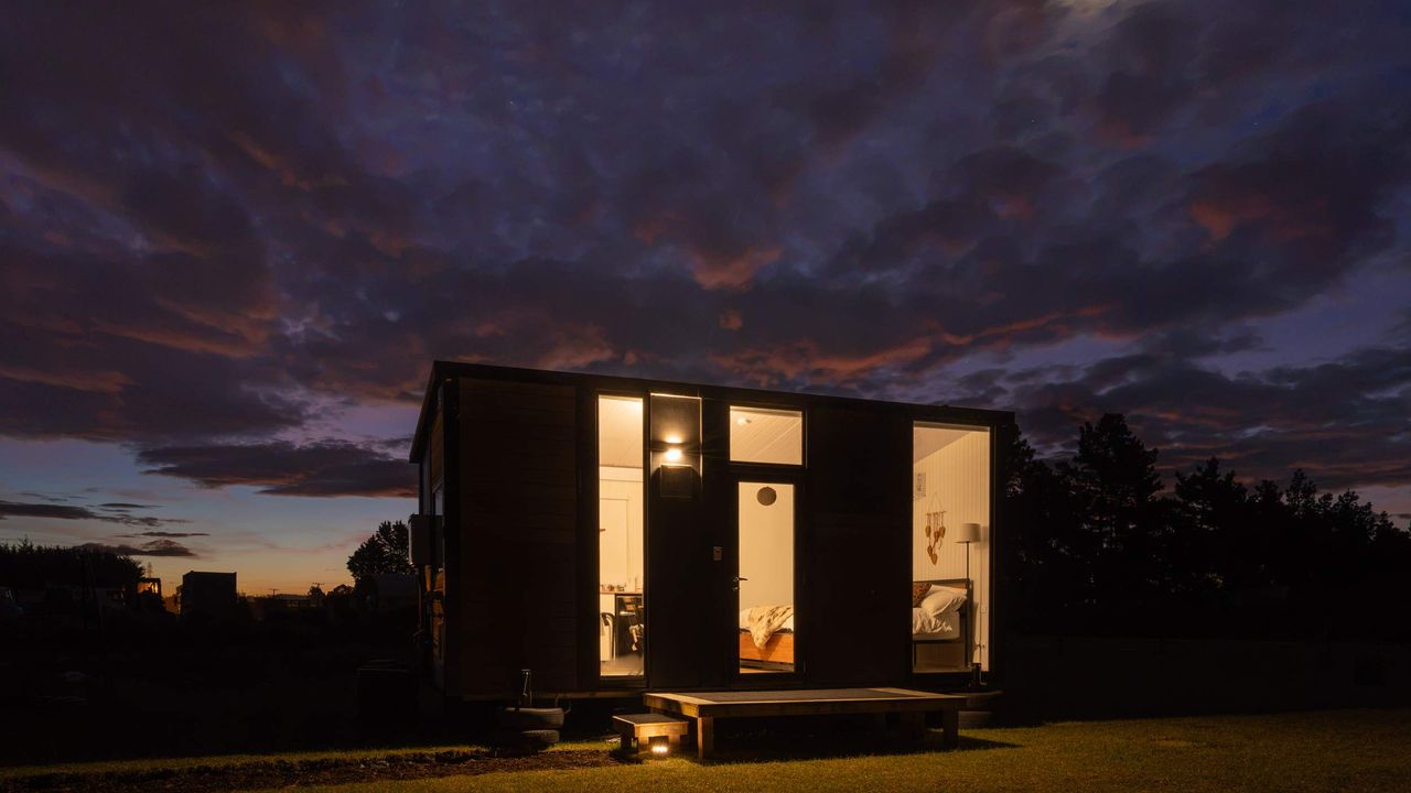 Tiny House with Clever Window Arrangement- night view with illumination