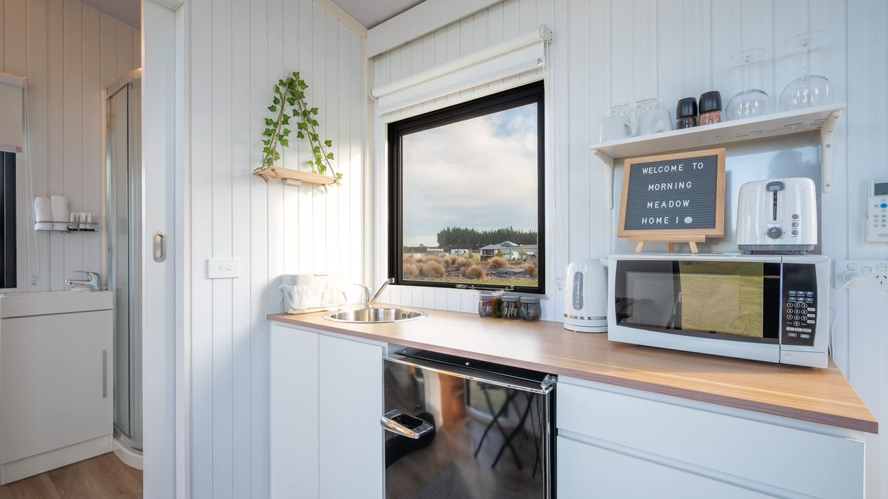Tiny House with Clever Window Arrangement - kitchen with a window