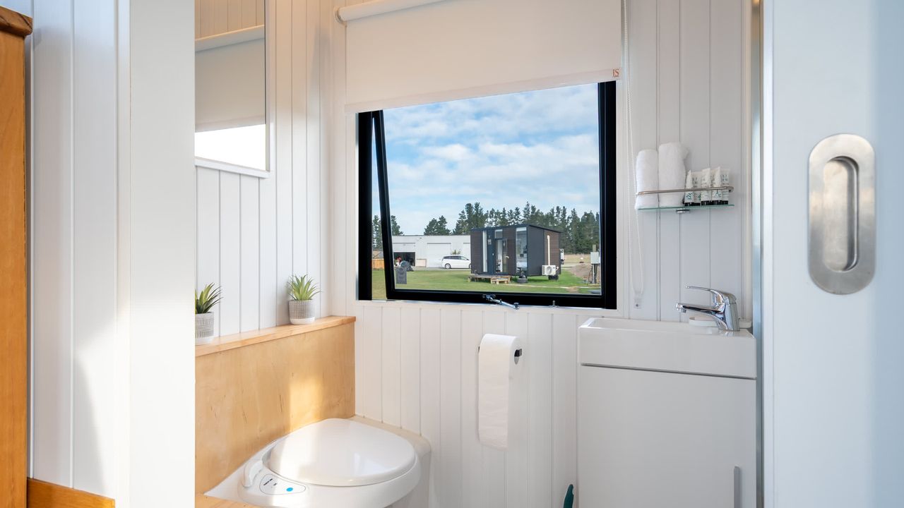 Tiny House with Clever Window Arrangement- bathroom with a window