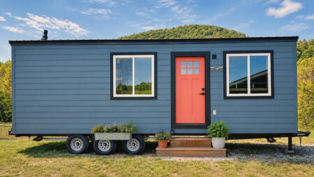 This $54k Wood-Wrapped Meadow Cottage on Wheels Tucks Loft Bedroom and Built-in Desk